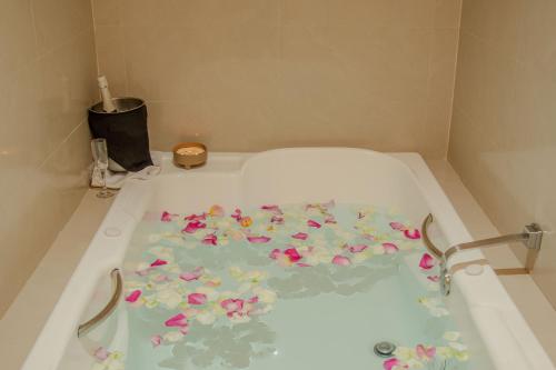 a bath tub filled with flowers in a bathroom at Casa Francisco in Cuernavaca