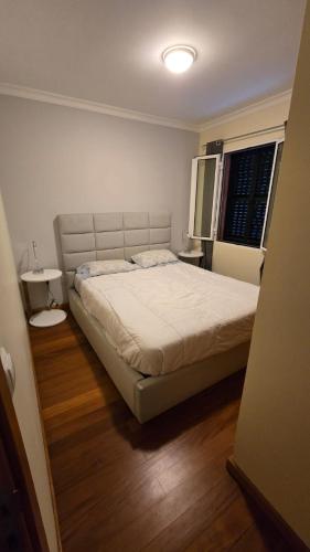 a bedroom with a large bed and a window at Jardim do Sol in Jardim do Mar