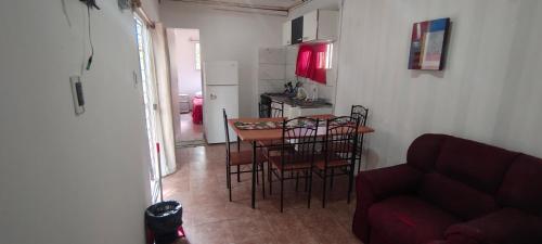 a living room with a table and chairs and a couch at Apartamento 2 Guazuvira in Guazuvira