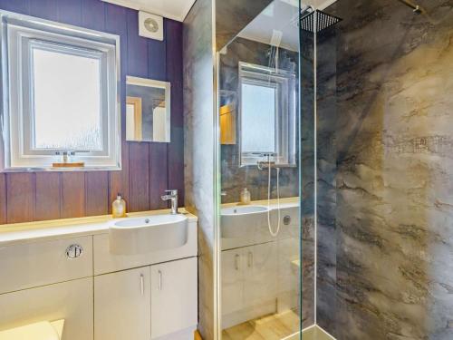 a bathroom with a shower and a sink at 1 Bed in Keswick oc-82476 in Bassenthwaite