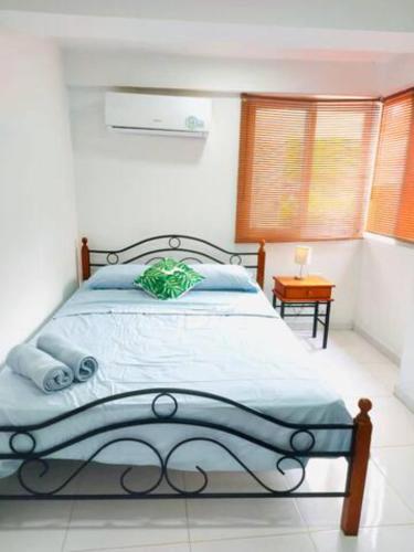a bedroom with a large bed with blue sheets at Villa Lourdes in Rousseau