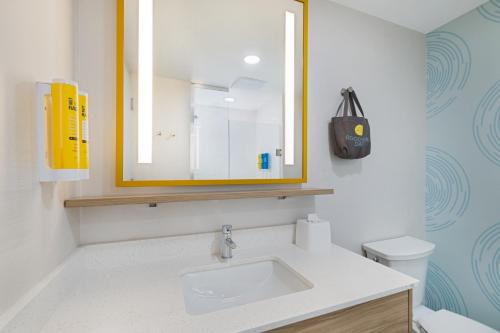 a bathroom with a sink and a mirror and a toilet at Tru By Hilton Miramar in Miramar