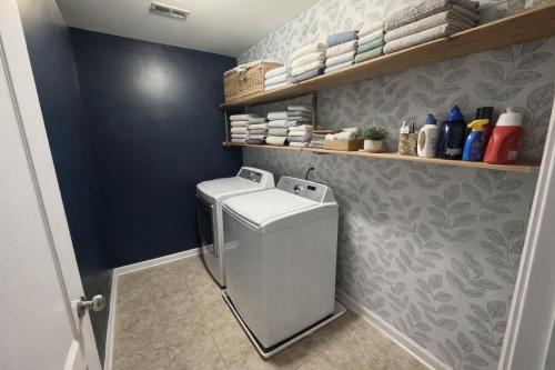 a small laundry room with a washer and dryer at The Bee & Bramble in Raeford