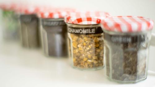 a row of jars filled with nuts and seeds at Finnis Studio in Napier