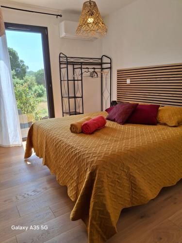 a bedroom with a large bed with a large window at GITE Mourèzeva in Mourèze