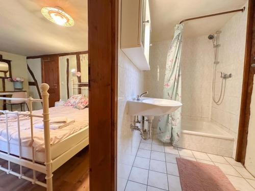 a bathroom with a bed and a sink and a tub at Neef in Neef