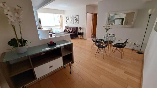 a living room with a table and chairs at City Towers Residential in Mexico City