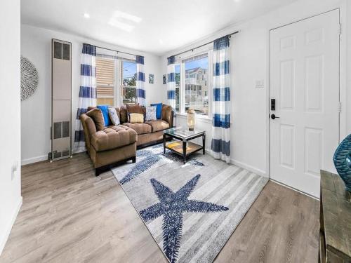 a living room with a couch and a starfish on a rug at Lbi - Ship Bottom, Duplex Available For Summer 2026 in Ship Bottom