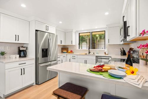 a kitchen with white cabinets and a white counter top at MA-1205 - Ocean Views AC in Koloa