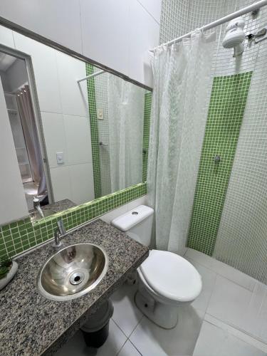 a bathroom with a toilet and a sink and a shower at Pousada do Horto in Juazeiro do Norte