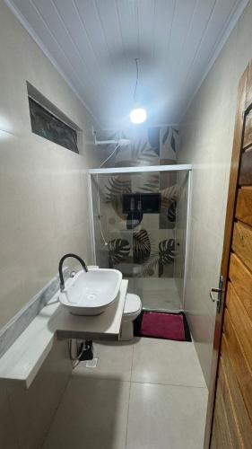 a bathroom with a sink and a toilet at Casa pôr do Sol in Aracaju