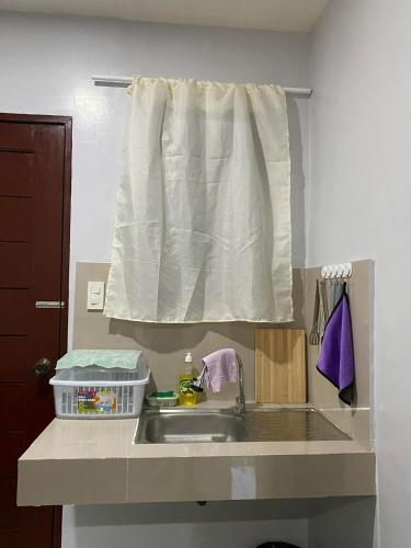 a kitchen counter with a sink and a window at Maple Leaf Residences - Unit 2 in Southern Davao