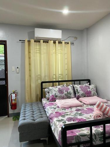 a bedroom with a bed with pink pillows at Maple Leaf Residences - Unit 2 in Southern Davao