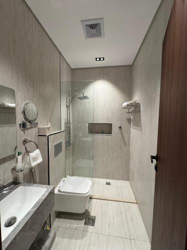 a bathroom with a toilet and a sink and a shower at فندق وفود فرع القريات in Al Qurayyat