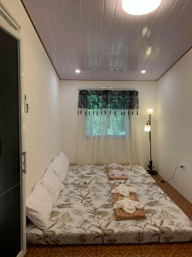 a large bed in a room with a window at Yaga's Stay INN save in Impasugong