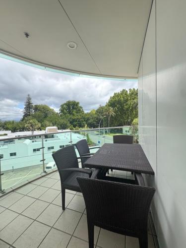 a patio with a table and chairs on a balcony at Apartment 303 Tauranga in Tauranga