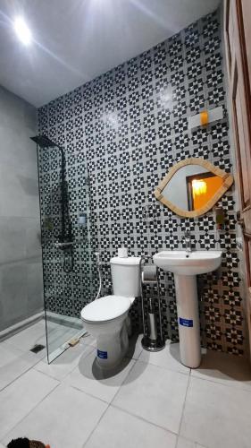 a bathroom with a toilet and a sink at Hotel & Riad Celia in Marrakesh