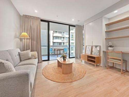 a living room with a couch and a table at Prime Location for an Event in Olympic Park in Sydney