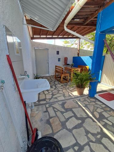 a bathroom with a sink and a table at Pousada Odoyá Beach - Quádrupla in Conde