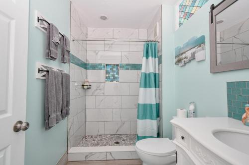 a bathroom with a shower and a toilet and a sink at Park Place Unit 130 in Cedar Key