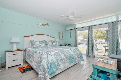 a bedroom with a bed with a white bedspread at Park Place Unit 130 in Cedar Key