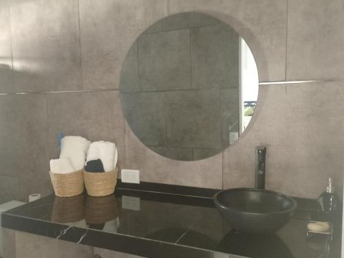 a bathroom with a sink and a mirror and towels at Lo de Mili in General Juan Madariaga