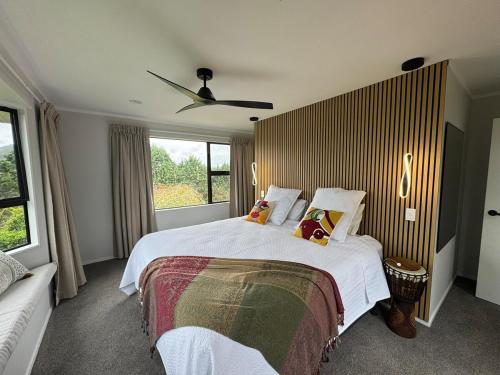 a bedroom with a large bed and a window at Taratara retreat in Kaeo