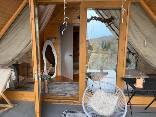 a room with a door and a chair in a tent at Cottage Sataplia in Kutaisi