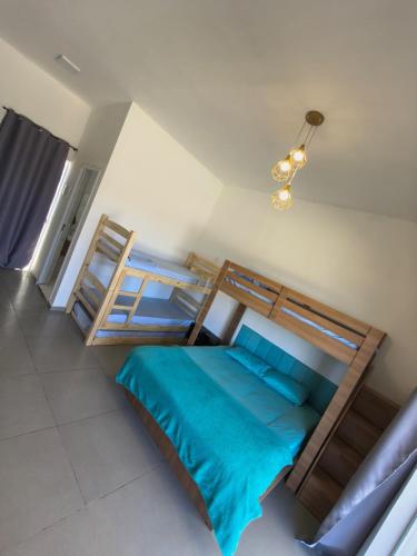 a bedroom with two bunk beds with blue sheets at JK Beach Club Bar e Pousada in Ibiúna