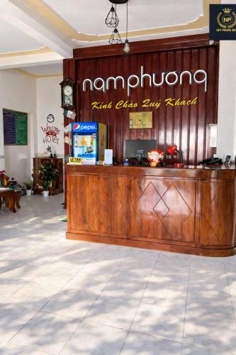 a restaurant with a wooden counter in a lobby at Nam Phương Hotel Sa Đéc in Sa Ðéc