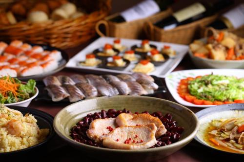 a table full of different types of food on plates at Hotel Takimoto in Yamanouchi