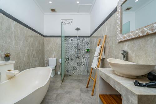 a bathroom with a tub and a sink and a shower at Made Ubud Villa by Bali Cabin in Ubud