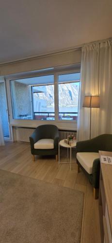 a living room with a couch and a chair at Bianca Apartment in Bissone