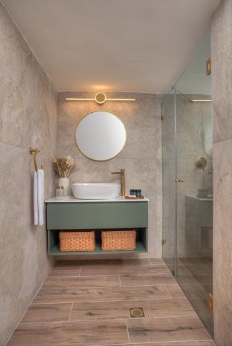 a bathroom with a sink and a shower at Keter HaSimta - כתר הסמטה in Safed