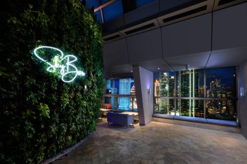 a green wall with a bicycle sign in a building at Traders Hotel, Kuala Lumpur in Kuala Lumpur