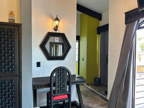 a hallway with a mirror and a chair at Hotel Villa's Camargo in Ixmiquilpan