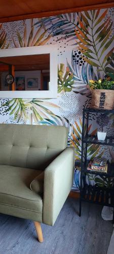 a living room with a couch and a colorful wall at Cabaña Chango in Coquimbo