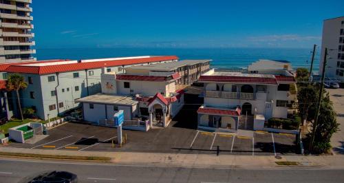 an aerial view of a building next to the ocean at La Bella Inn - POOL OPEN in Daytona Beach