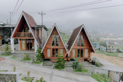 a wooden house with a pitched roof at Zaada Villa Dieng Syariah By Travelink in Kejajar