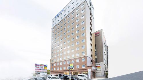 a rendering of a hotel with cars parked in a parking lot at Toyoko Inn Kita-asaka-eki Nishi-guchi in Asaka