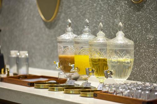 a table with three glass vases filled with drinks at Mercure Beijing City Center in Beijing