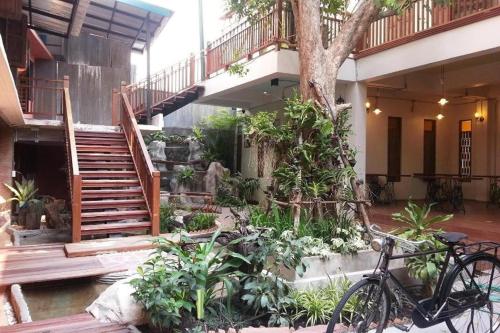 a bike parked in front of a building with a staircase at P1 House Phitsanulok in Ban Nong Chaeng