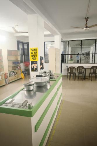 a kitchen with a counter with pots and pans on it at Home Nest in Anand