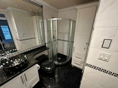 a bathroom with a shower and a sink at Luxury Room with Private Washroom in Prime Location in Vancouver