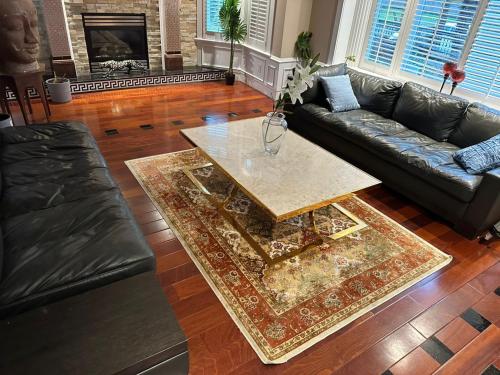 a living room with a couch and a coffee table at Luxury Room with Private Washroom in Prime Location in Vancouver