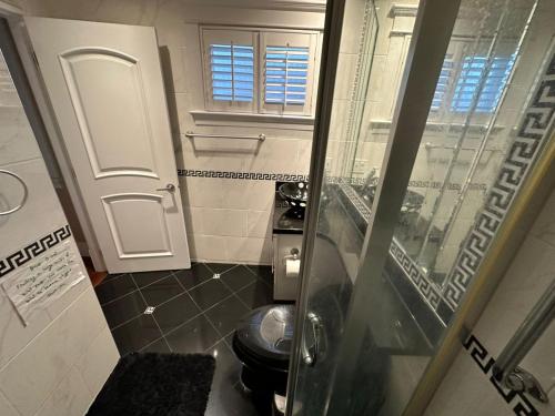 a small bathroom with a toilet and a window at Luxury Room with Private Washroom in Prime Location in Vancouver