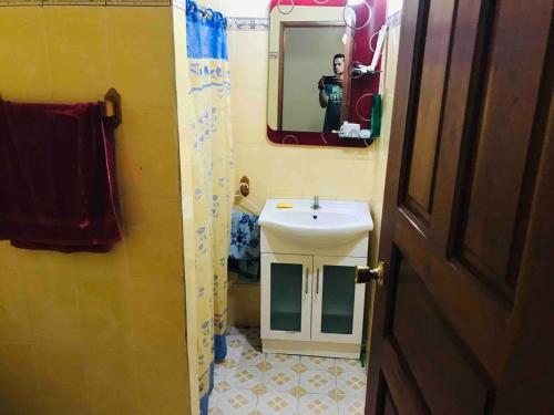 a person taking a picture of a bathroom with a sink at Casa estilo campestre in Chitré