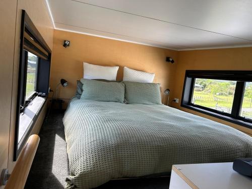 a bedroom with a large bed in a room at Gorgeous private tiny home in  Waipukurau