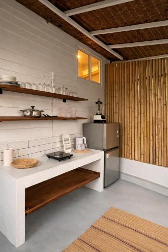 a kitchen with a white counter and a refrigerator at Little Mountain Nest in Haad Pleayleam