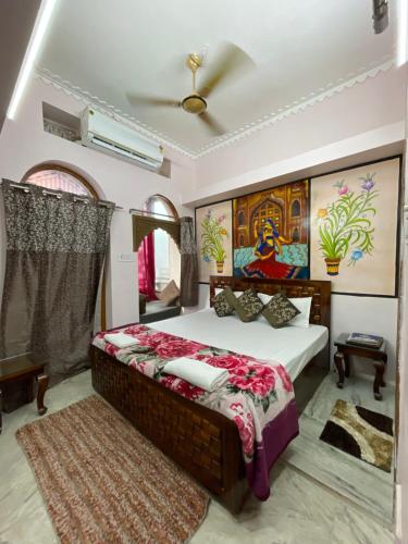 a bedroom with a bed and a ceiling fan at The Rajputana Heritage in Jodhpur